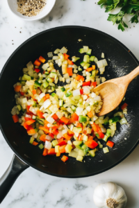 This image shows garlic being added to the pan, infusing the dish with a delicious aroma as it cooks.