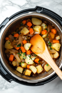 This image shows diced potatoes and vegetable broth being poured into an Instant Pot, ready to be pressure-cooked until tender.