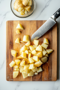 chopping-peeled-potatoes-into-small-bite-sized-pieces