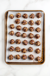 cooling-and-hardening-chocolate-peanut-butter-clusters-on-baking-sheet-top-down-view