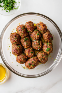 This image shows the spiced chicken mixture being divided into equal portions on a plate. Each portion is shaped carefully to ensure even cooking and perfect texture in the final dish.