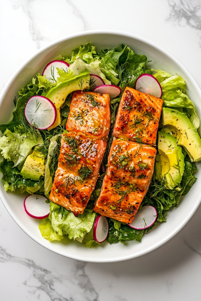 This image shows the finished avocado salmon salad plated in a white bowl, with a beautifully smoked salmon fillet on top, ready to serve.