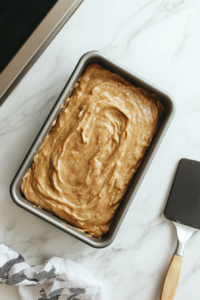 pouring-banana-bread-batter-into-loaf-pan-before-baking-to-golden-perfection