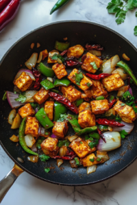 stir-frying-whole-chilies-onions-and-capsicum-for-extra-flavor
