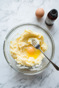 stirring-in-fragrant-vanilla-extract-and-eggs-for-enhanced-banana-bread-flavor