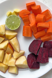 Chop the beetroot, carrots, apple, and celery