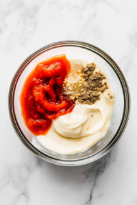 combining-sriracha-lime-chipotle-sesame-oil-and-garlic-powder-into-mayo-for-flavor-boost