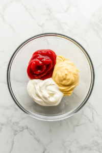 mixing-mayonnaise-ketchup-and-mustard-together-in-a-small-bowl-for-burger-sauce-base-2
