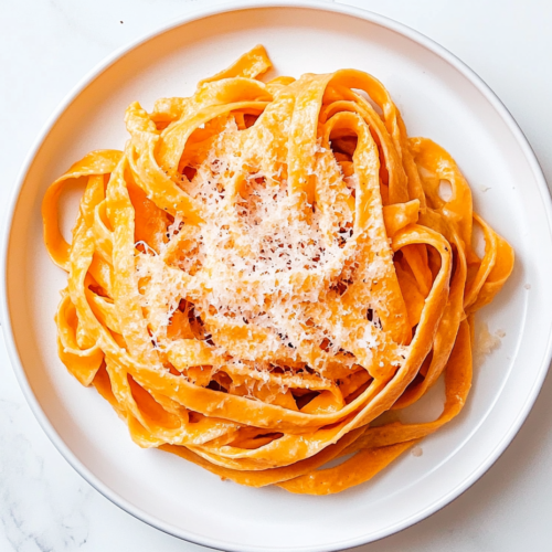 pumpkin-alfredo-pasta-in-a-round-white-plate-topped-with-grated-parmesan-2