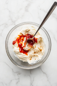 whisking-all-spicy-mayo-ingredients-until-smooth-and-creamy-3