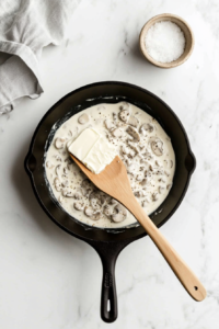 adding-minced-garlic-and-sliced-mushrooms-to-the-pan-with-sauteed-onions