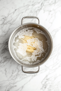 adding-starchy-pasta-water-to-skillet-sauce