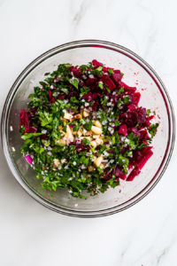 This image shows the completed beetroot salad, fresh and vibrant, served in a glass bowl after being chilled, ready to enjoy.