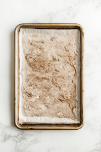 chocolate-swiss-roll-batter-spread-onto-lined-baking-sheet
