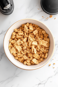 coarsely-crumbling-graham-crackers-on-a-cutting-board-for-a-textured-dessert-layer