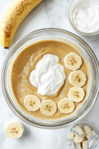 This image shows eggs being added one by one to the butter-sugar mixture along with a generous splash of vanilla extract for flavor