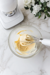 creamy-peanut-butter-and-butter-blended-in-glass-bowl-on-white-marble-cooktop