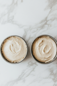 divide-the-batter-into-pans-and-pat-them-properly-to-avoid-air-bubbles