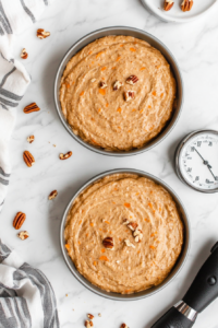 dividing-the-batter-between-pans-and-placing-them-in-the-oven