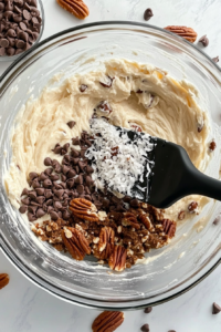 This image shows the batter being divided into round cake pans, ready to be baked to golden and fluffy layers.