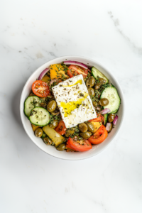 This image shows a thick slice of feta cheese resting atop the salad, finished with a generous drizzle of olive oil for a perfect Greek touch.