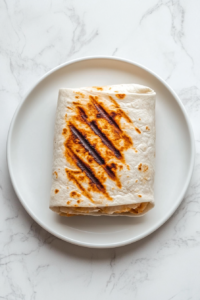 grilled-burrito-with-golden-crisp-marks-on-a-plate-ready-to-serve