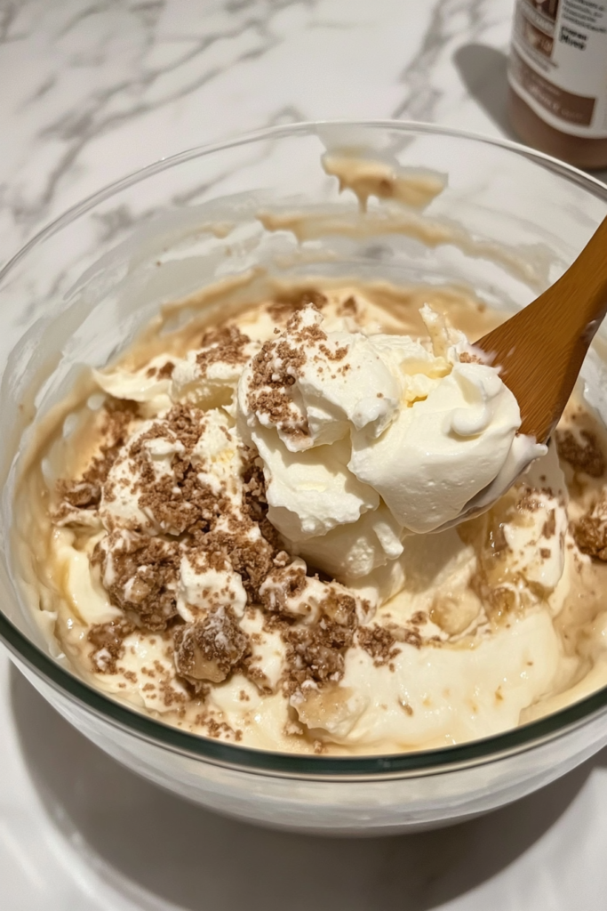 layering-vanilla-wafers-bananas-and-cream-in-trifle-dish-6797921-683x1024