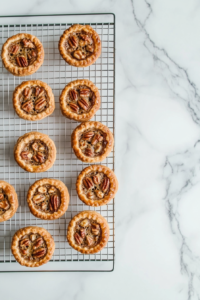 mini-pecan-pies-cooling-on-a-wire-rack-after-coming-out-of-the-oven