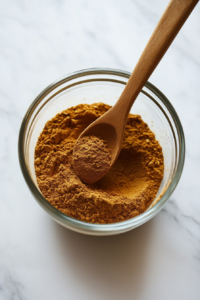 This image shows dry ingredients, including oats and warm spices, being mixed in a large bowl to create the signature textured base for the Parkin cake.