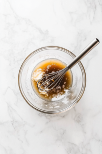 mixing-golden-brown-sugar-butter-and-vanilla-for-pecan-pie-filling-2