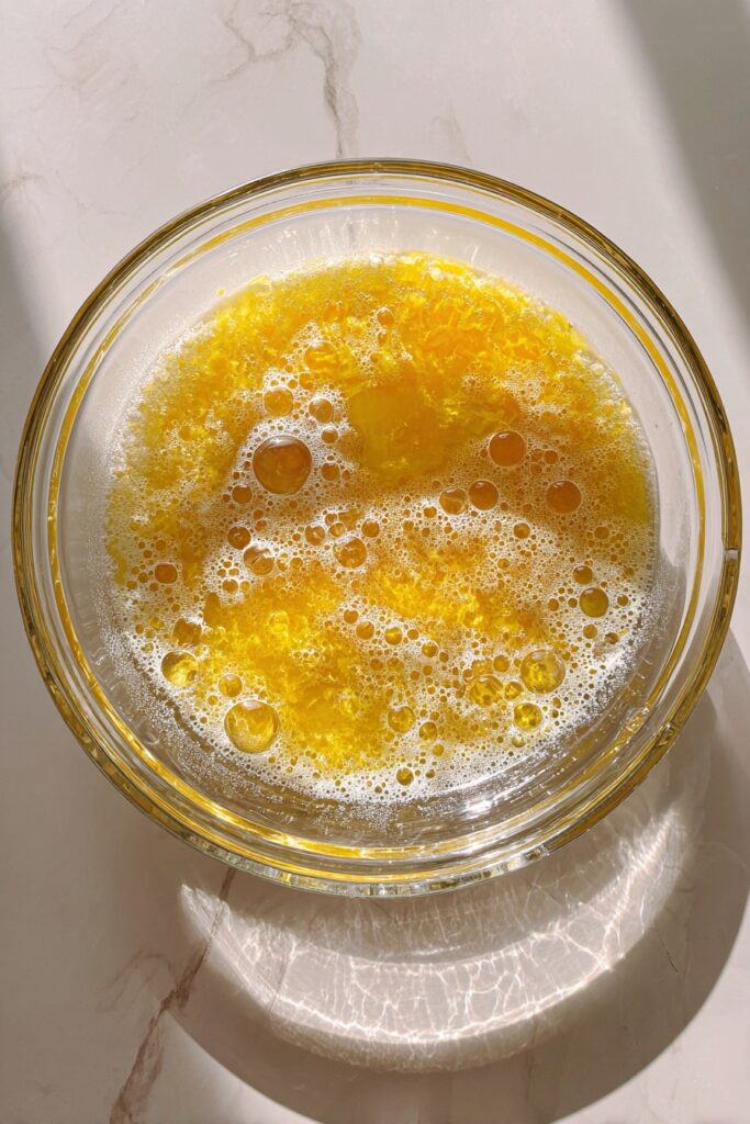 mixing-lemon-syrup-juice-and-sparkling-water-in-glass-bowl