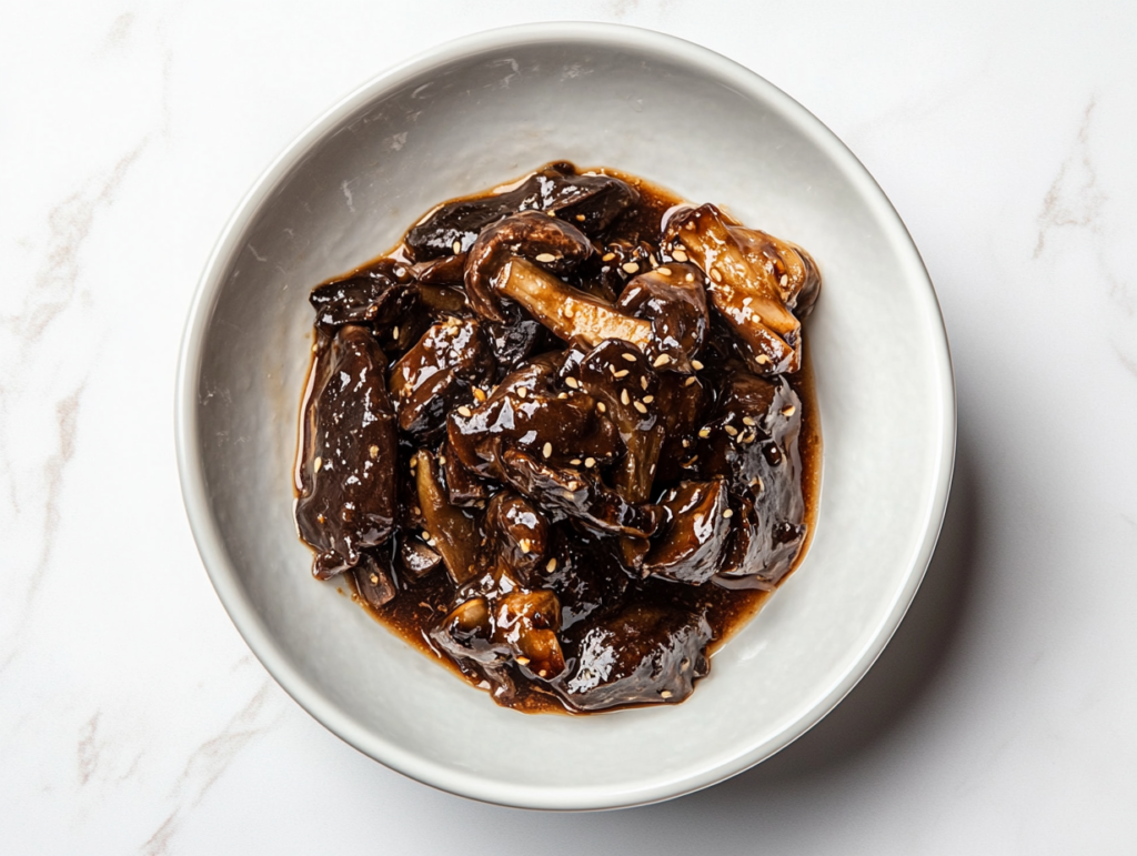 This image shows a beautifully plated dish of roasted carrots glazed in a shiny sauce and topped with fresh cilantro leaves for a burst of color and flavor.