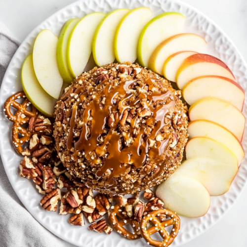 pecan-pie-cheese-ball-topped-with-caramel-and-pecans-served-with-apple-slices