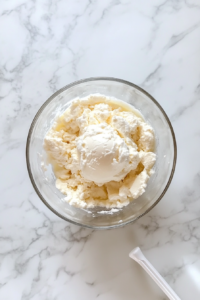 This image shows thin apple slices artfully arranged over the tart base in a circular, overlapping pattern.
