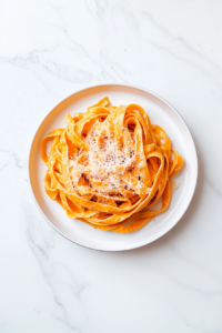 plated-pumpkin-alfredo-fettuccine-garnished-with-parmesan-and-herbs