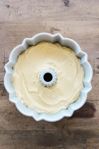 pour the batter gently over the chopped nuts