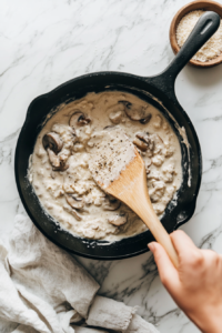pouring-cream-and-adding-butter-into-the-pan-to-create-a-rich-alfredo-base