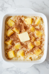 pouring-mixture-into-dish-and-adding-butter-and-cinnamon