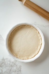 rolling-dough-and-pressing-into-pie-pan-for-perfect-cheesecake-base