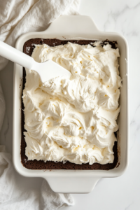 slicing-and-serving-chocolate-cake-roll-with-fudge-sauce-top-down