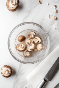 This image shows the oven being preheated while a baking sheet is lined with parchment paper, getting ready for the carrots to be roasted.