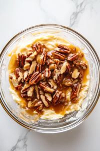 spooning-cold-caramel-and-pecan-mix-into-the-center-of-cheese-well