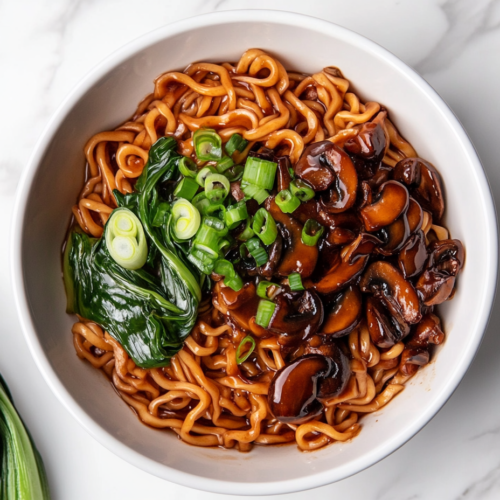 teriyaki-noodles-in-white-bowl-tossed-in-savory-sauce-with-green-onions-and-beans