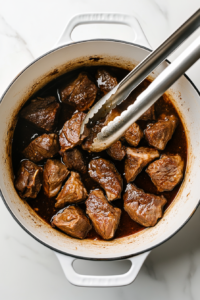 transferring-seared-lamb-from-skillet-to-dutch-oven
