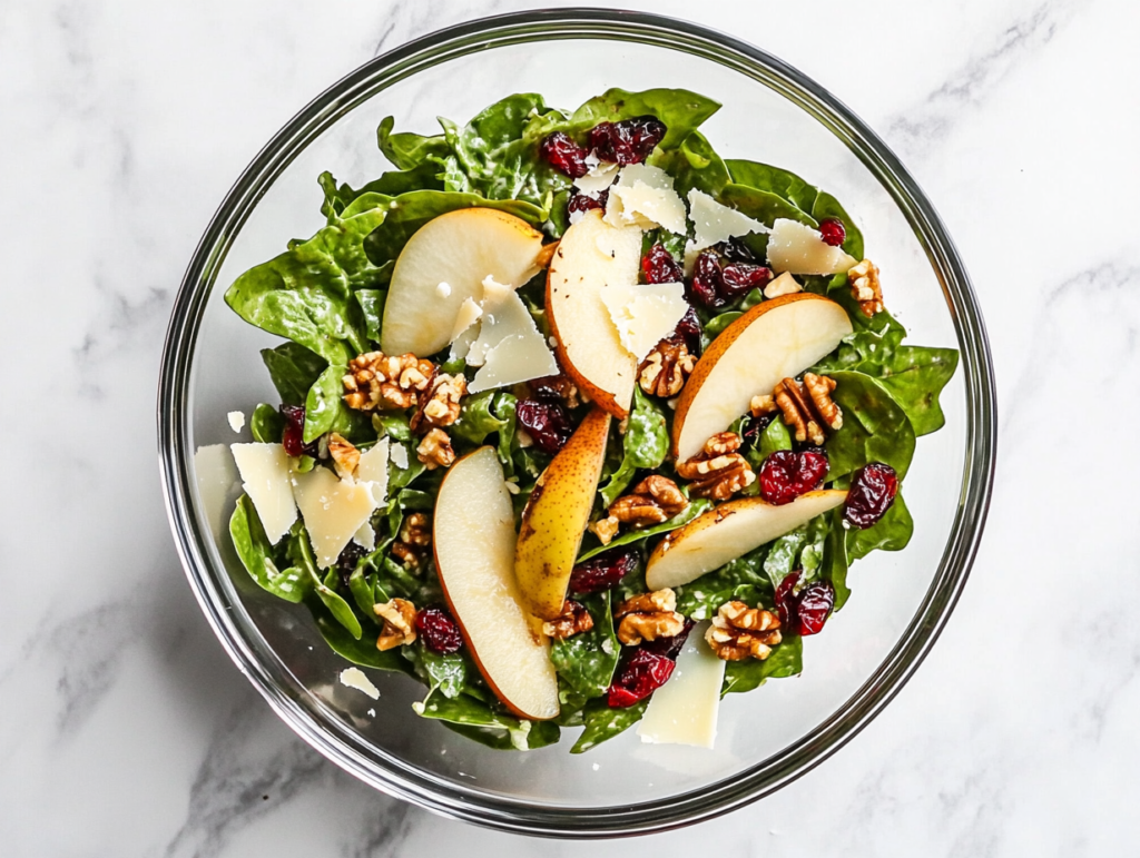 vibrant-autumn-salad-with-sliced-pears-mixed-greens-candied-pecans-and-goat-cheese-in-a-white-serving-bowl