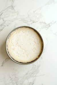 whipping-cream-and-icing-sugar-in-metal-bowl-being-whipped-into-soft-peaks-with-hand-mixer