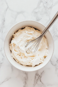whisking-instant-chocolate-pudding-with-cold-milk-in-a-glass-bowl-until-thick-and-smooth