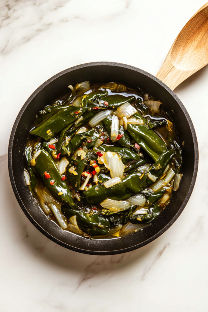 adding-freshly-minced-garlic-to-the-skillet-for-chicken-poblan-7696370-683x1024