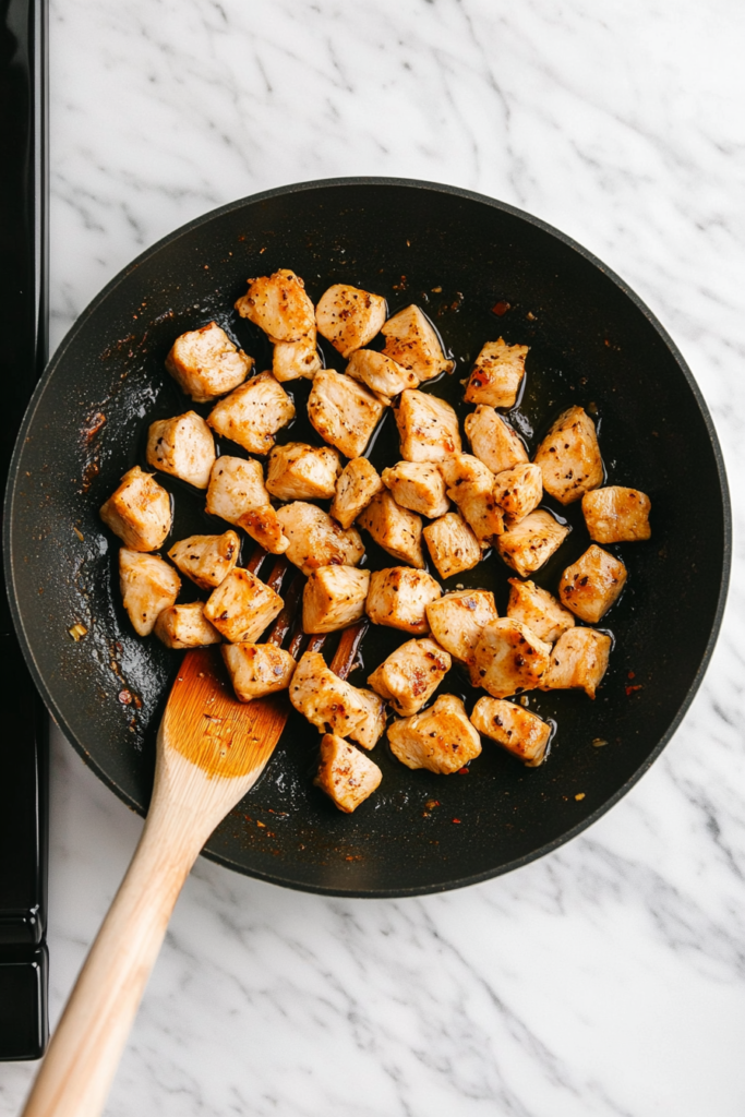 chicken-pieces-being-cooked-to-a-perfect-golden-brown-for-a-flavorful-teriyaki-bowl-3327347-683x1024