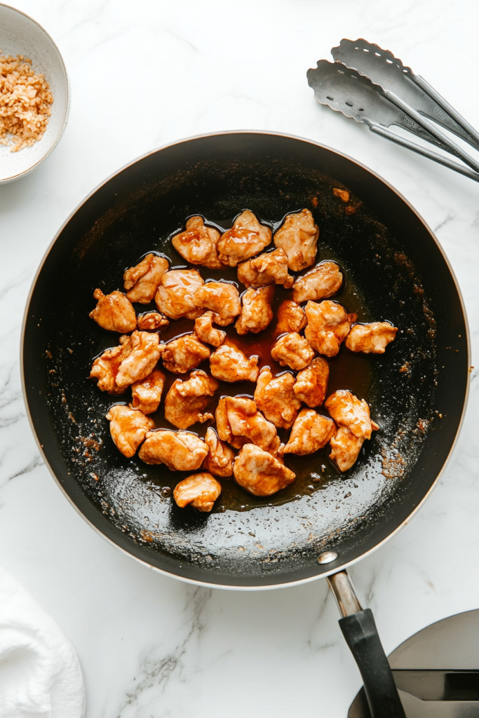 frying-chicken-pieces-in-hot-oil-for-crispiness-6561177-683x1024